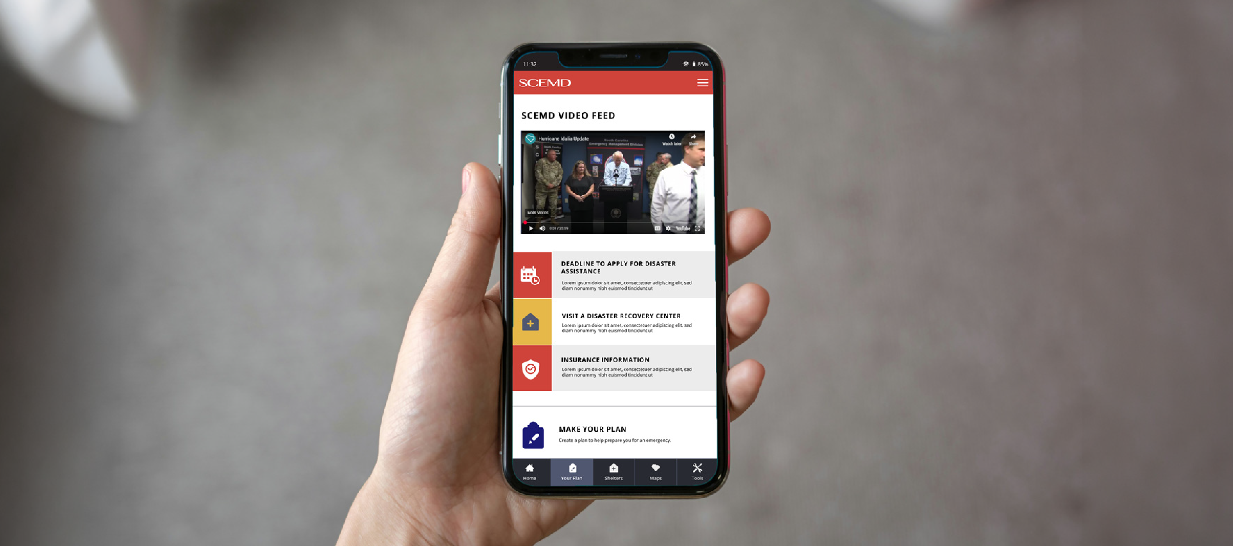 image of hand holding a phone displaying the SCEMD app